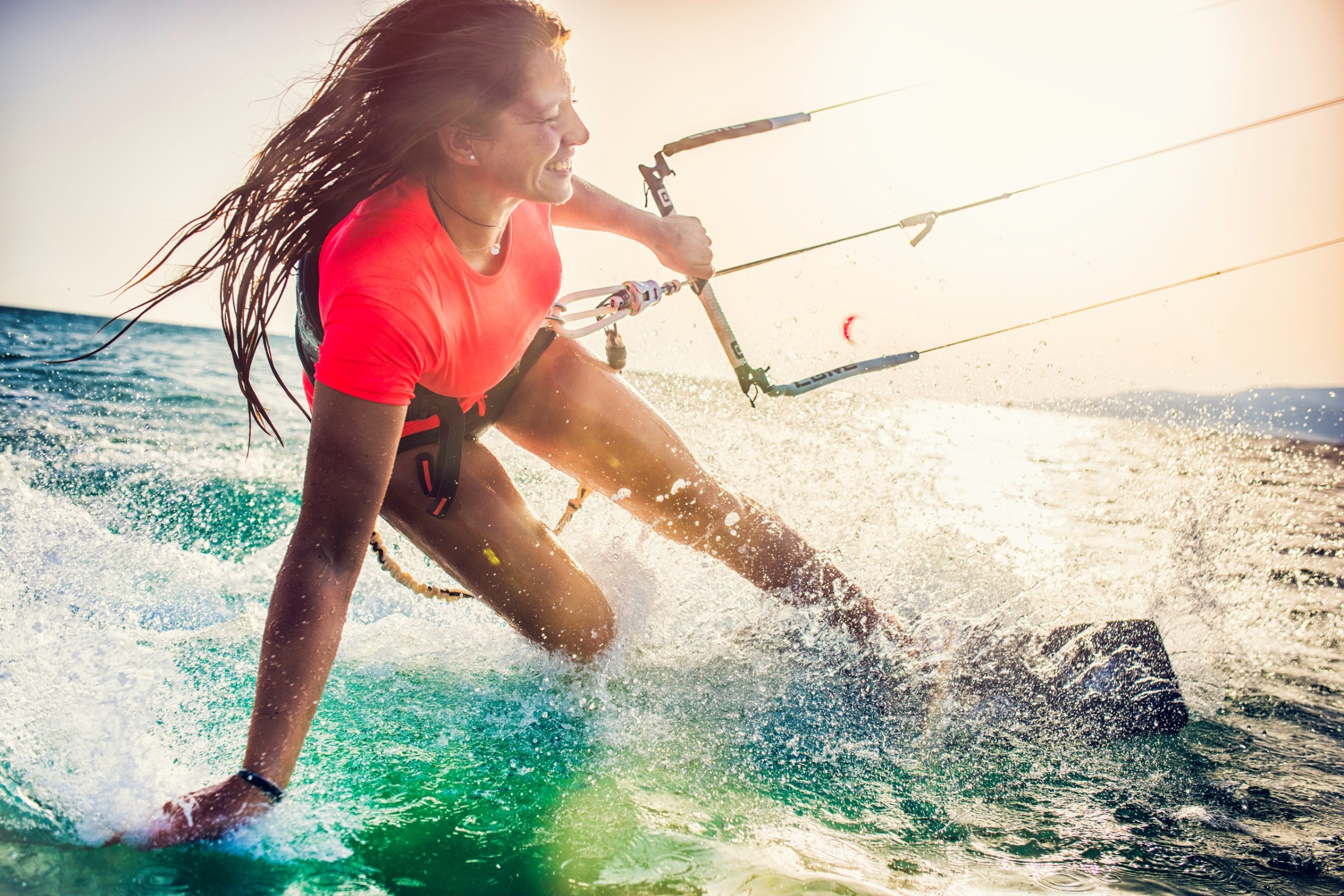 a person riding a wave while kitesurfing