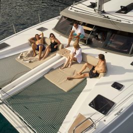 a group of people sitting on a catamaran