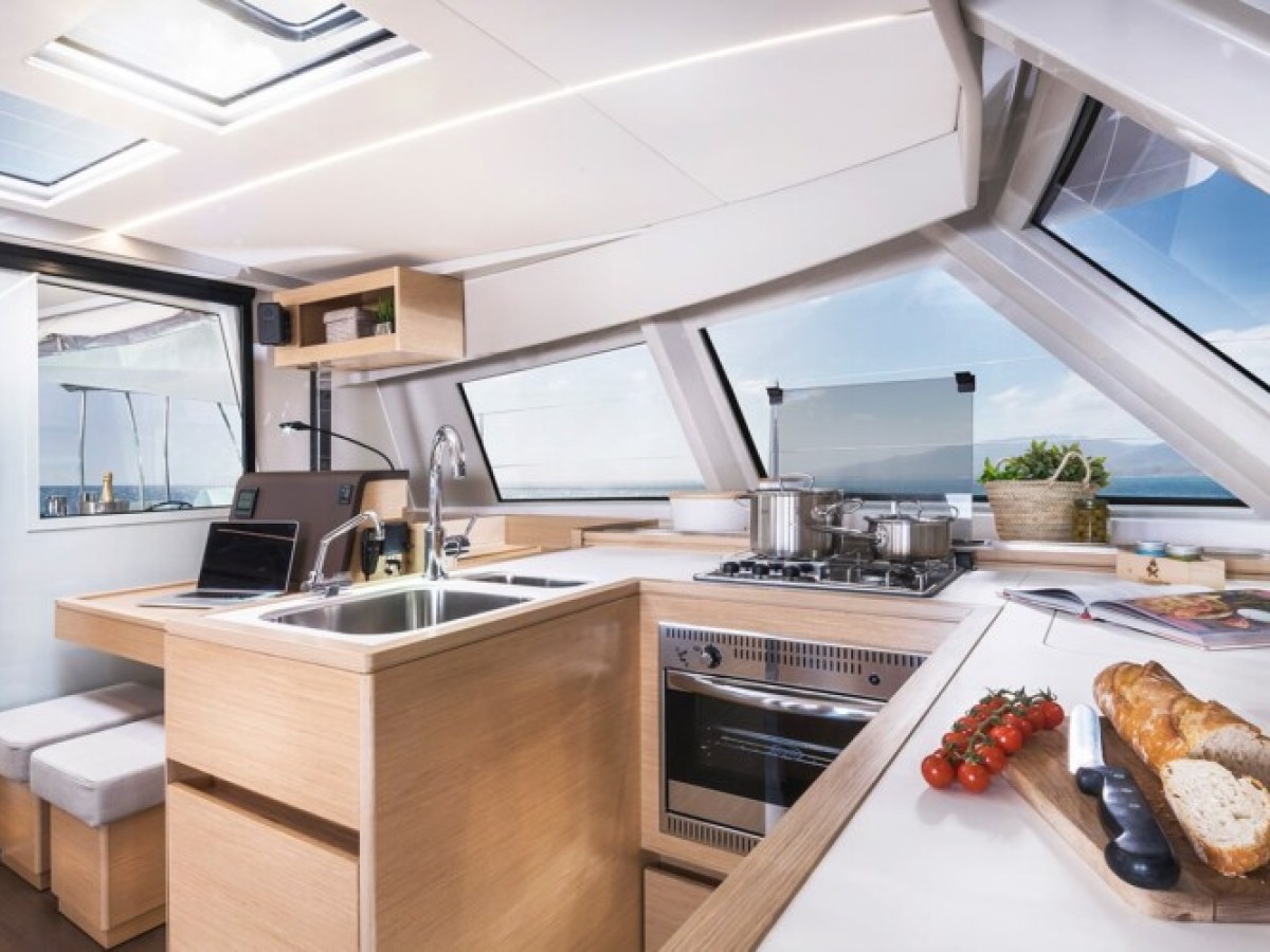 a kitchen with food on a table in a catamaran