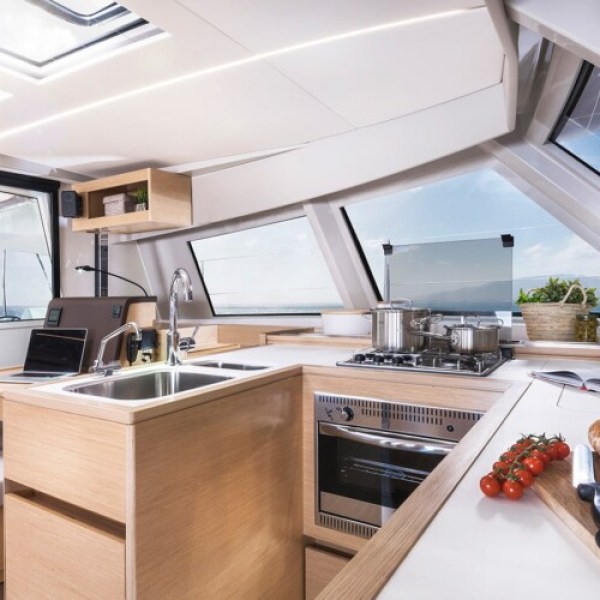 a kitchen with food on a table in a catamaran