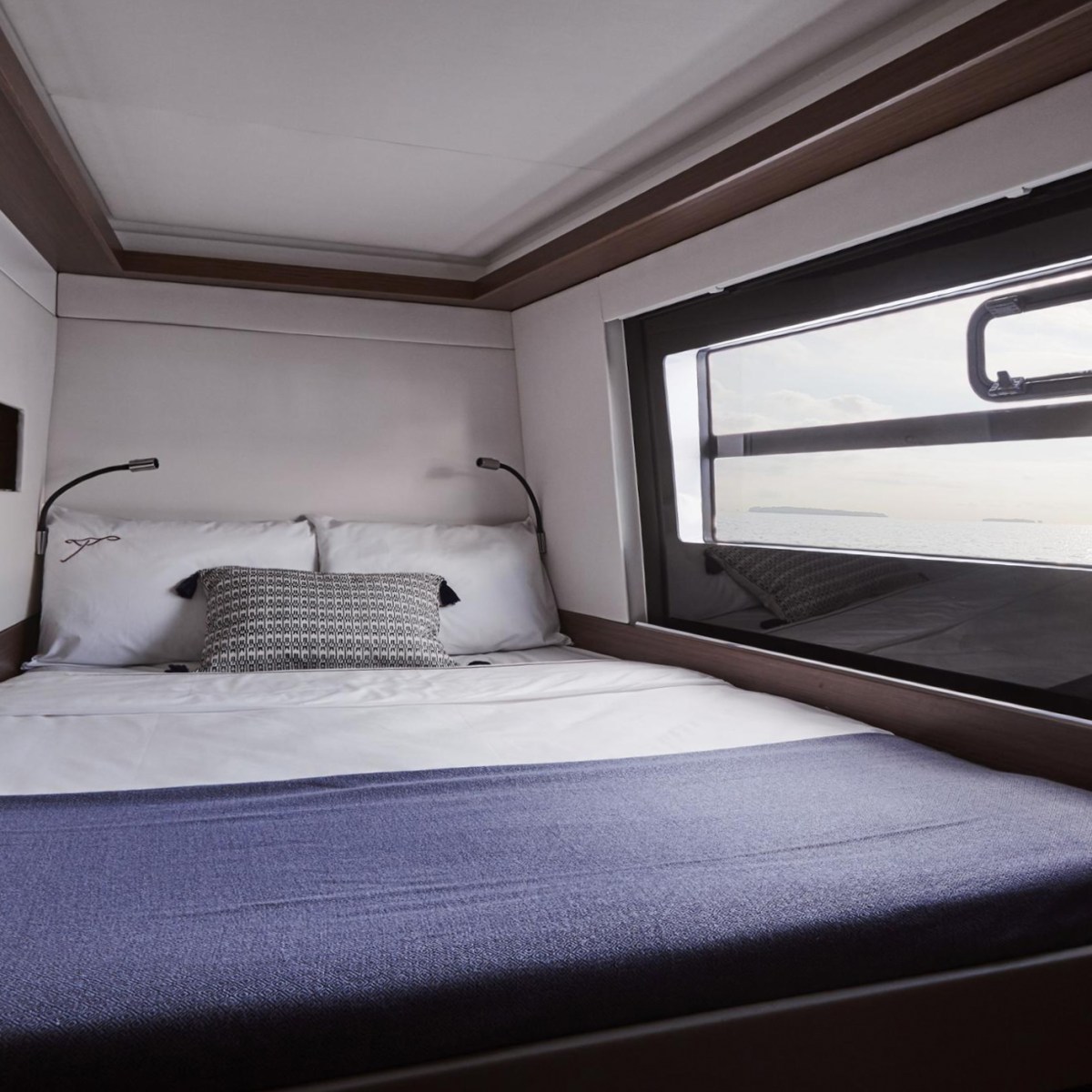 Compact bedroom with a double bed, window view, and modern decor.