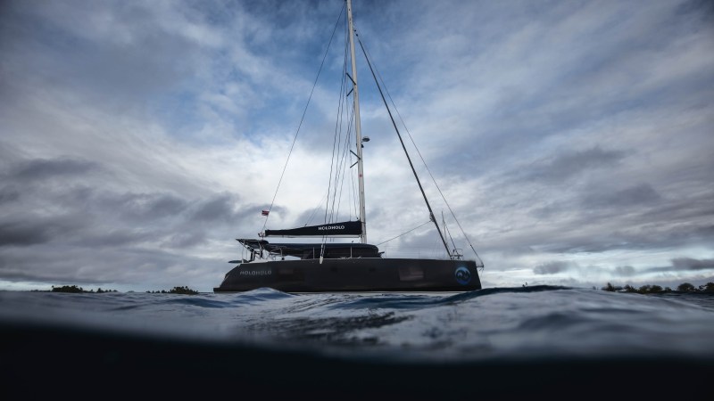 Sailboat on choppy water under a cloudy sky.