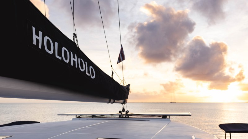 View from a boat deck with sunset sky and ocean horizon.
